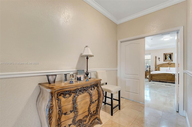 corridor featuring light tile patterned floors, crown molding, and a textured wall