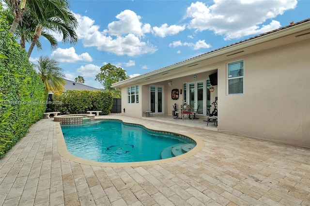 view of pool with a patio, fence, french doors, and a pool with connected hot tub
