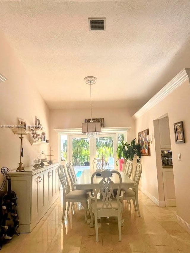 19720 SW 79th Ct, Cutler Bay, FL 33189 - dining area featuring plenty of natural light, a chandelier, a textured ceiling, french doors, and light tile patterned floors