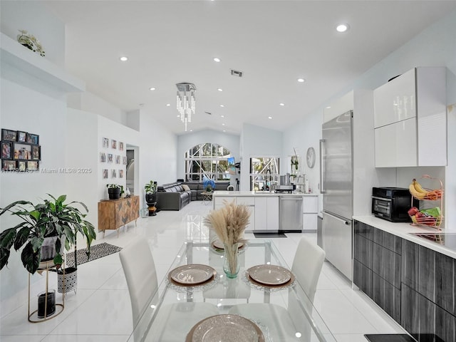 dining space featuring visible vents, recessed lighting, light tile patterned flooring, and lofted ceiling