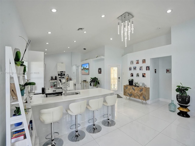 kitchen with light tile patterned flooring, visible vents, a sink, and recessed lighting