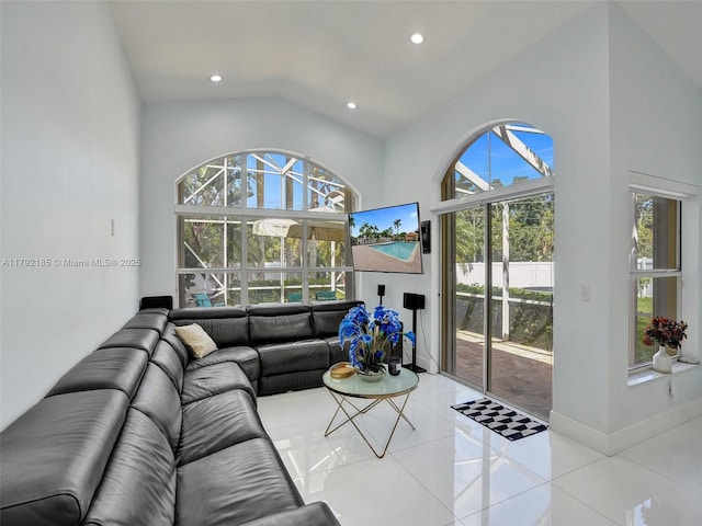 living room with recessed lighting, light tile patterned flooring, and high vaulted ceiling