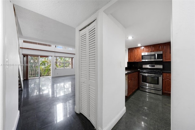 17911 NW 68th Ave Unit P208, Hialeah, FL 33015 - kitchen featuring recessed lighting, stainless steel appliances, granite finish floor, dark countertops, and baseboards