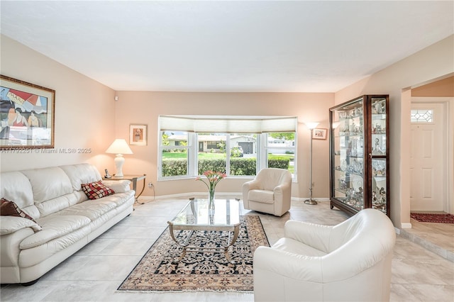 living area with baseboards and light tile patterned flooring