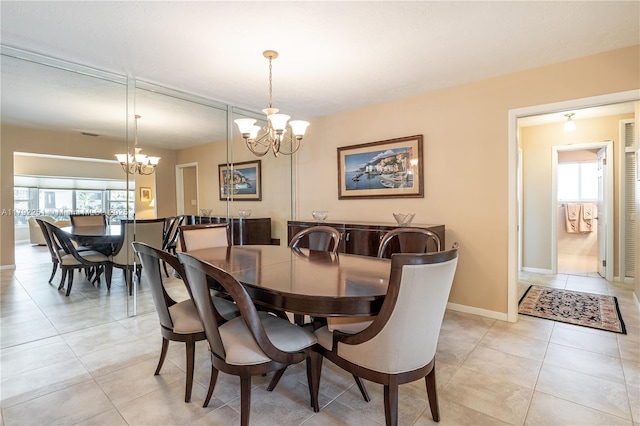 dining room featuring light tile patterned floors, a chandelier, and a healthy amount of sunlight