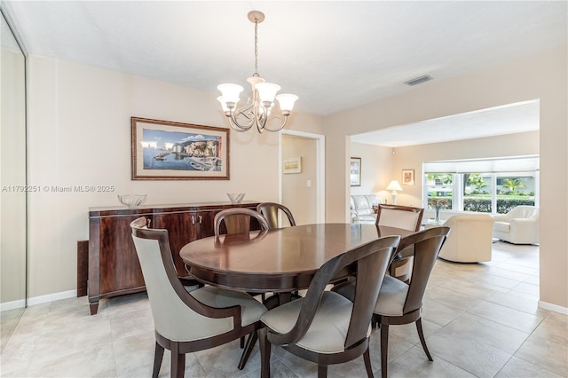 dining area with an inviting chandelier, baseboards, light tile patterned floors, and visible vents