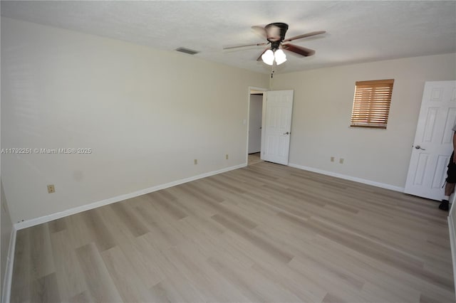 unfurnished bedroom with visible vents, a ceiling fan, baseboards, and light wood-style floors