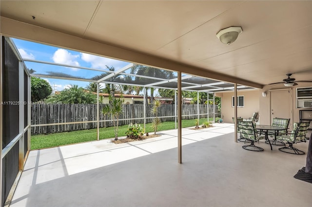 unfurnished sunroom with ceiling fan and outdoor dining space