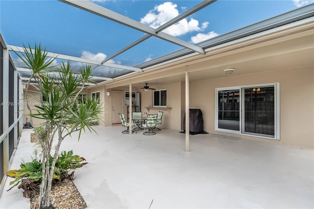view of patio / terrace with glass enclosure and a ceiling fan