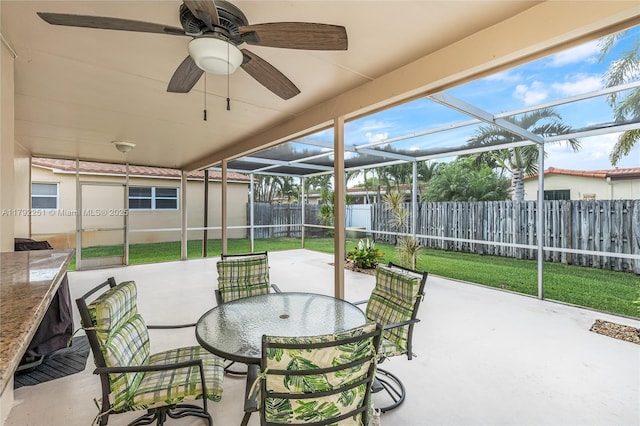 sunroom / solarium featuring a ceiling fan and outdoor dining space