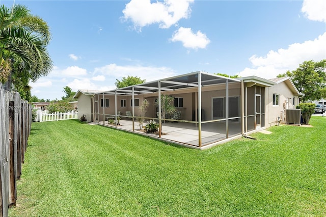 back of house featuring fence, cooling unit, a yard, a patio, and stucco siding