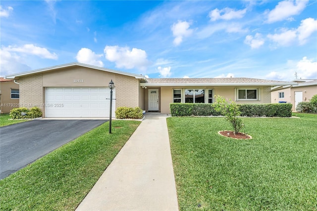 ranch-style home with a front lawn, brick siding, a garage, stucco siding, and driveway