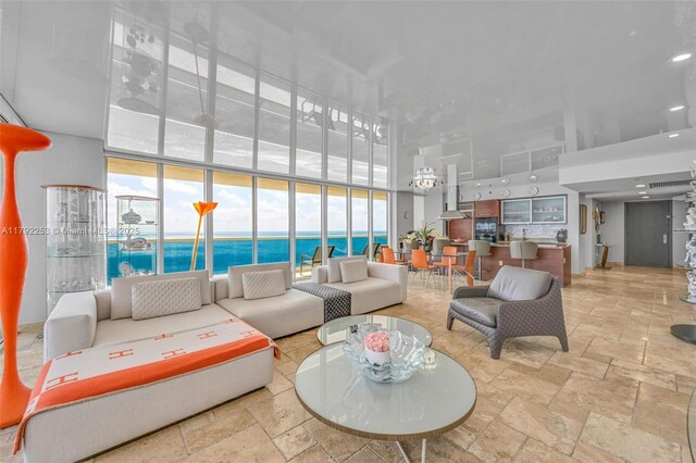 1830 S Ocean Dr Unit 1201, Hallandale Beach, FL 33009 - living area featuring a water view, a high ceiling, and stone tile flooring