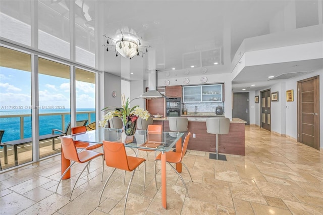 1830 S Ocean Dr Unit 1201, Hallandale Beach, FL 33009 - dining area with a water view, recessed lighting, expansive windows, and stone tile floors