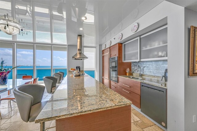 1830 S Ocean Dr Unit 1201, Hallandale Beach, FL 33009 - kitchen featuring stainless steel dishwasher, stone tile floors, brown cabinetry, and modern cabinets