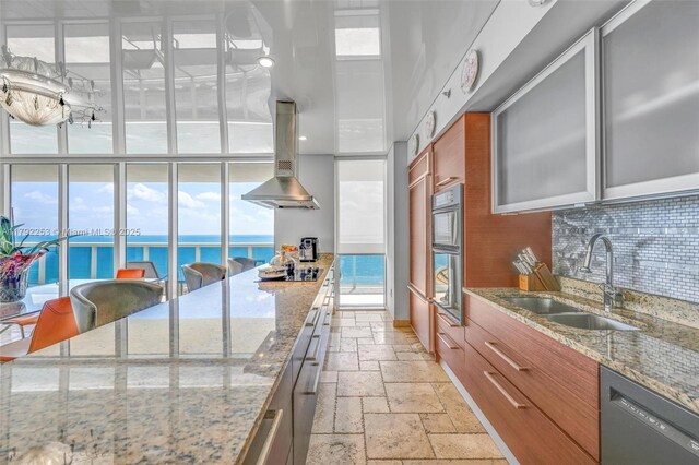 1830 S Ocean Dr Unit 1201, Hallandale Beach, FL 33009 - kitchen featuring stone tile flooring, island range hood, tasteful backsplash, a sink, and black appliances