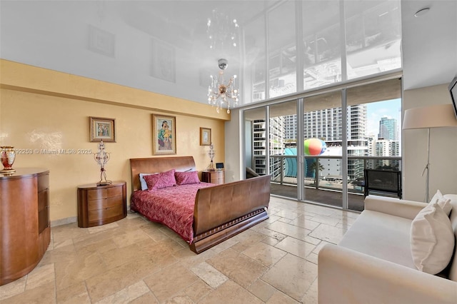 1830 S Ocean Dr Unit 1201, Hallandale Beach, FL 33009 - bedroom featuring a high ceiling, a notable chandelier, access to exterior, baseboards, and stone tile flooring