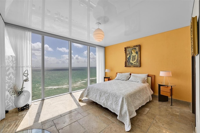 1830 S Ocean Dr Unit 1201, Hallandale Beach, FL 33009 - bedroom with stone tile flooring, a water view, access to exterior, and a wall of windows