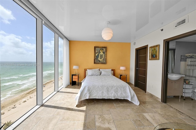 1830 S Ocean Dr Unit 1201, Hallandale Beach, FL 33009 - bedroom with visible vents, stone tile floors, access to exterior, a water view, and a view of the beach