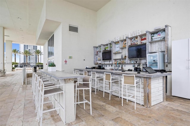 1830 S Ocean Dr Unit 1201, Hallandale Beach, FL 33009 - kitchen with visible vents, open shelves, and a breakfast bar area