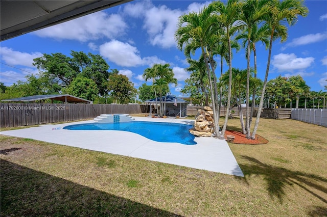 view of swimming pool featuring a patio area, a fenced backyard, a fenced in pool, and a lawn