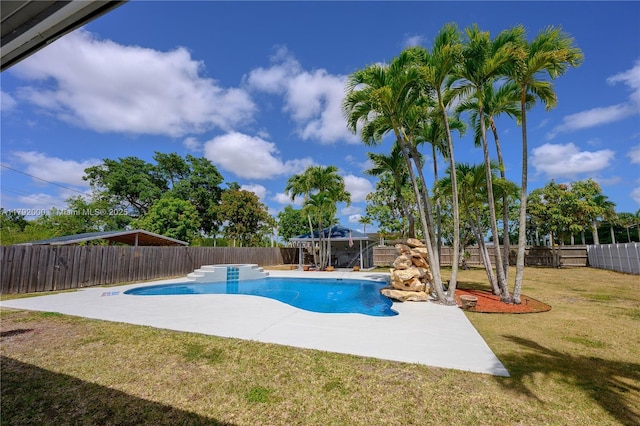 view of swimming pool with a lawn, a fenced in pool, a patio, and a fenced backyard