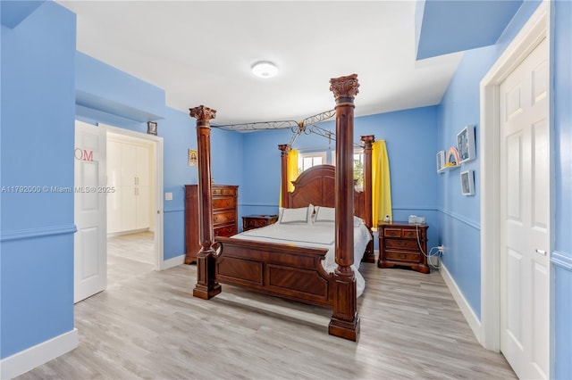 bedroom with baseboards and light wood-type flooring