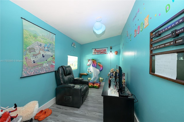 interior space with baseboards and wood finished floors