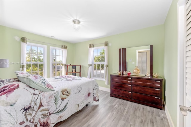 bedroom featuring baseboards and wood finished floors