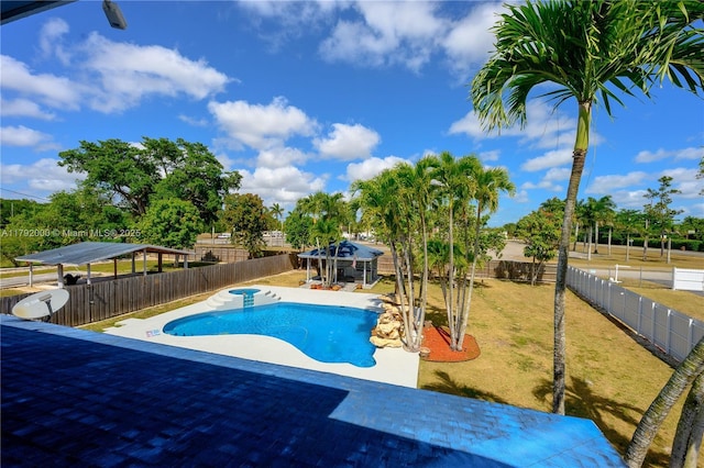 view of pool with an outdoor structure, a patio, a fenced in pool, a storage structure, and a fenced backyard