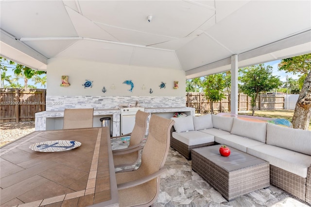 view of patio / terrace with outdoor dining area, an outdoor hangout area, and a fenced backyard