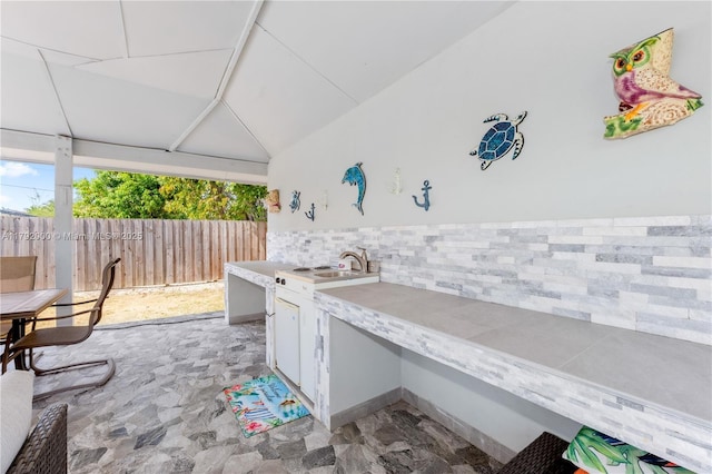 view of patio / terrace with fence and a sink