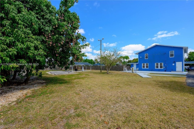 view of yard featuring fence, a gazebo, and a detached carport