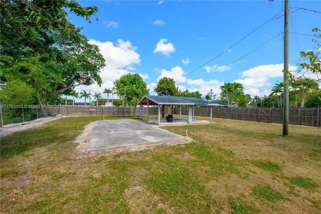 view of yard featuring a gazebo, a carport, and a fenced backyard