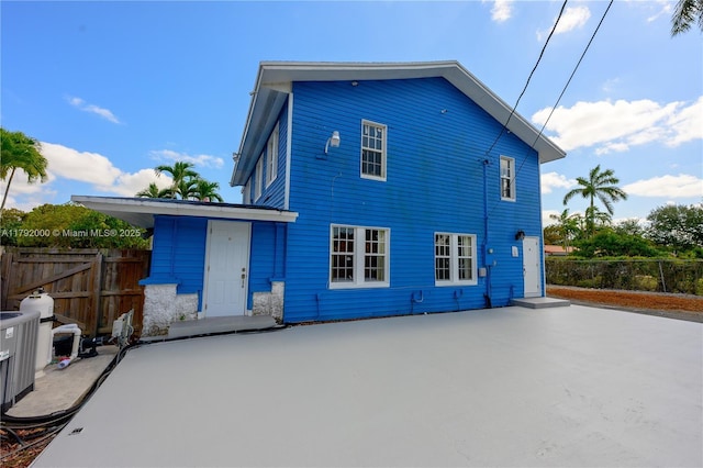 rear view of property with fence and a patio area