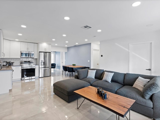 living area with visible vents and recessed lighting