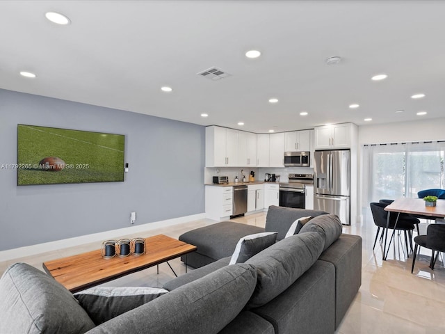 living area with visible vents, light tile patterned floors, a toaster, and recessed lighting