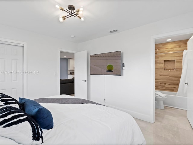 bedroom with an inviting chandelier, ensuite bath, a closet, visible vents, and light tile patterned flooring
