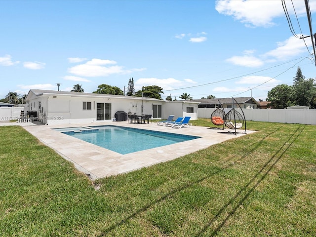 view of pool featuring fence, a patio area, a lawn, and a fenced in pool