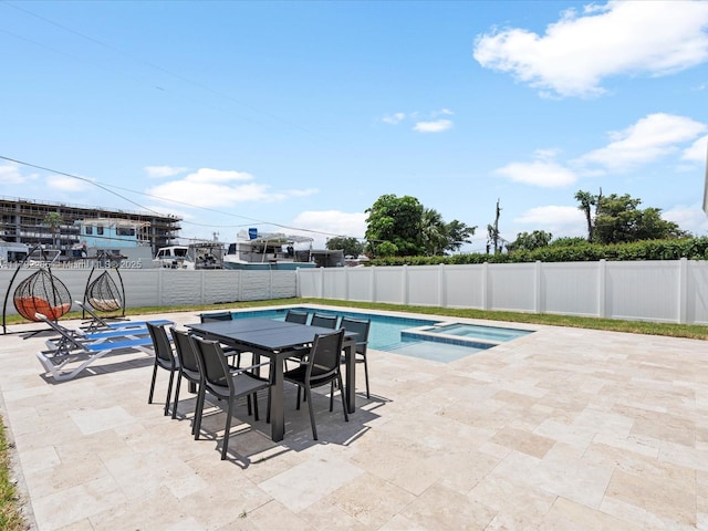 view of swimming pool with outdoor dining space, a fenced backyard, and a patio area
