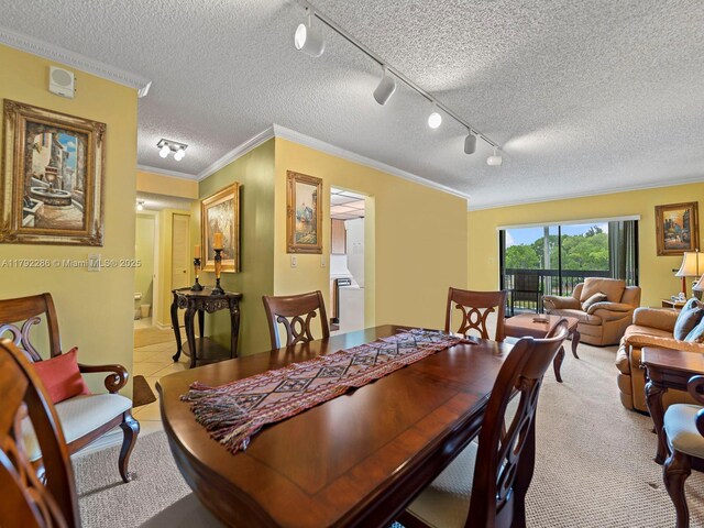 1300 SW 122nd Ave Unit 303-2, Miami, FL 33184 - dining area featuring a textured ceiling, ornamental molding, and track lighting