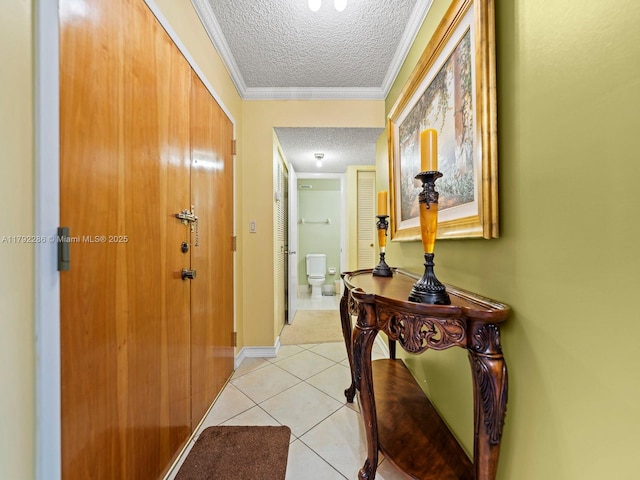 1300 SW 122nd Ave Unit 303-2, Miami, FL 33184 - hall featuring a textured ceiling, light tile patterned floors, baseboards, and ornamental molding