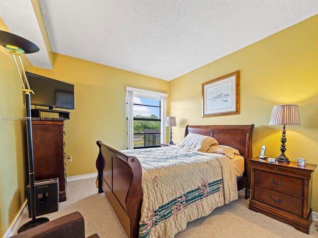 1300 SW 122nd Ave Unit 303-2, Miami, FL 33184 - bedroom with carpet floors, baseboards, and a textured ceiling