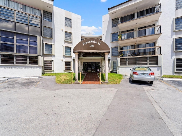 1300 SW 122nd Ave Unit 303-2, Miami, FL 33184 - view of building exterior with uncovered parking