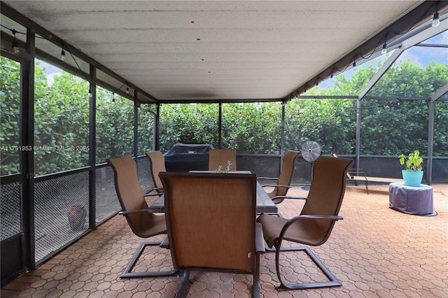 sunroom featuring outdoor dining space