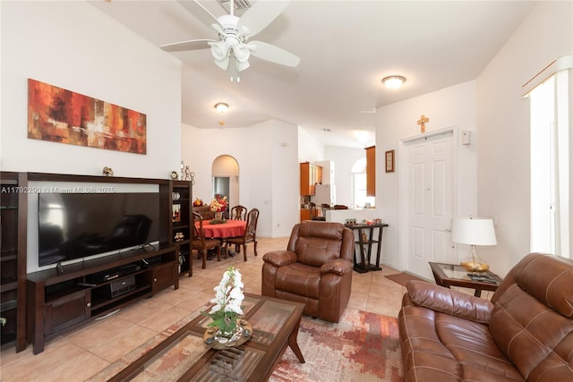 living room with light tile patterned flooring and a ceiling fan
