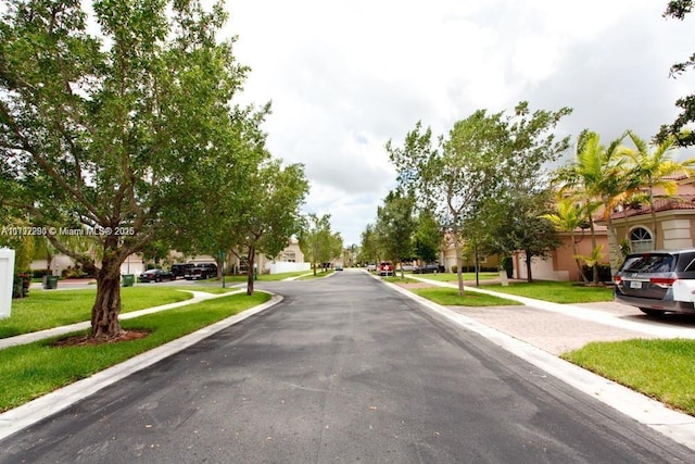 view of road featuring curbs, sidewalks, and a residential view