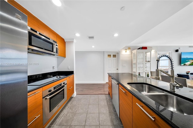 50 Biscayne Blvd Unit 4004, Miami, FL 33132 - kitchen featuring brown cabinets, a sink, visible vents, stainless steel appliances, and modern cabinets