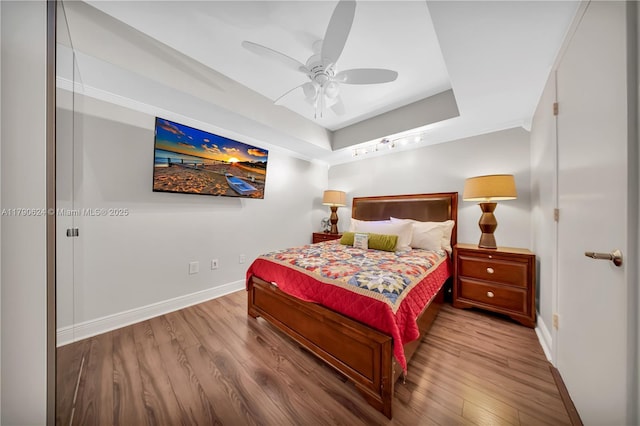 50 Biscayne Blvd Unit 4004, Miami, FL 33132 - bedroom with wood finished floors, a ceiling fan, a tray ceiling, and baseboards