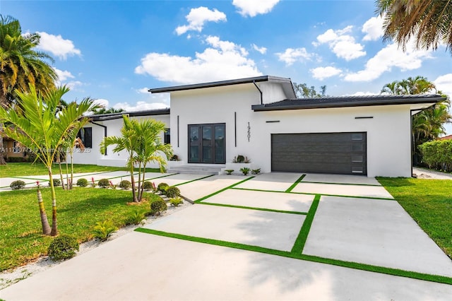 19601 E Saint Andrews Dr, Hialeah, FL 33015 - contemporary house featuring stucco siding, a front lawn, concrete driveway, and an attached garage